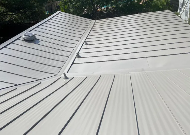 Solar attic fan installed on a metal roof for Roof Ventilation in Shorewood